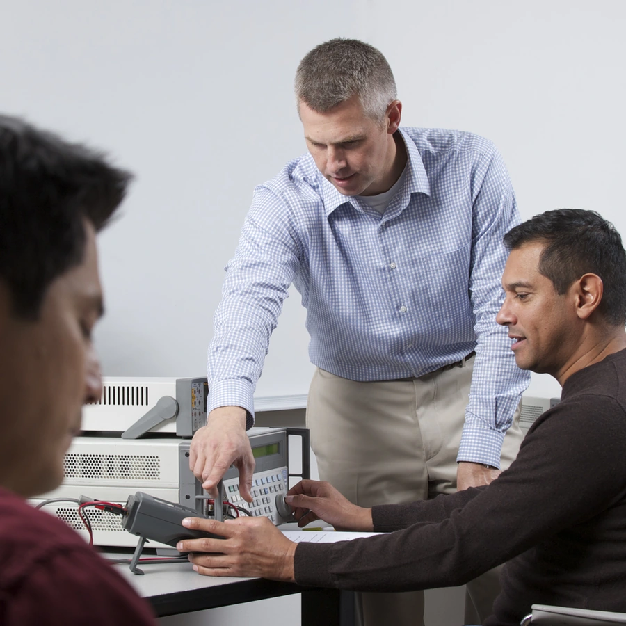 Instructor teaching calibration to participants using professional test equipment