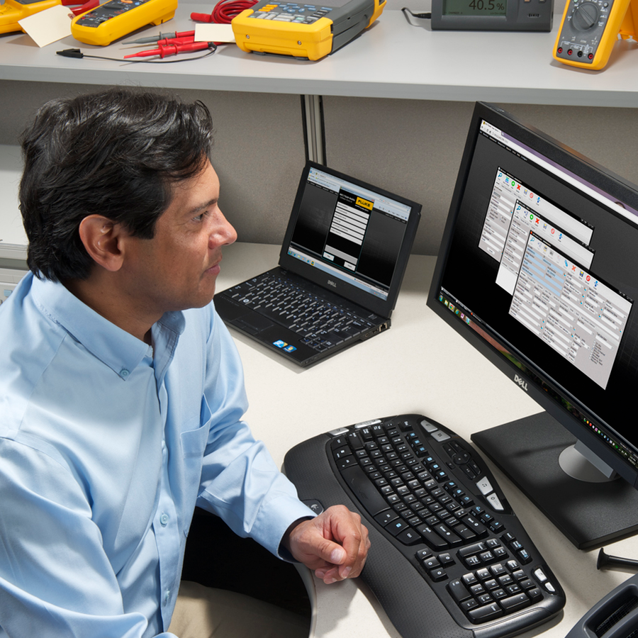 Calibration professional working with calibration software at a computer workstation