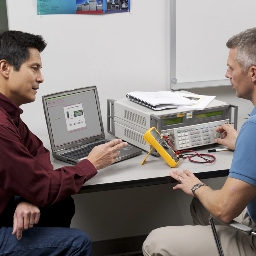 Instructor providing hands-on calibration training with Fluke equipment